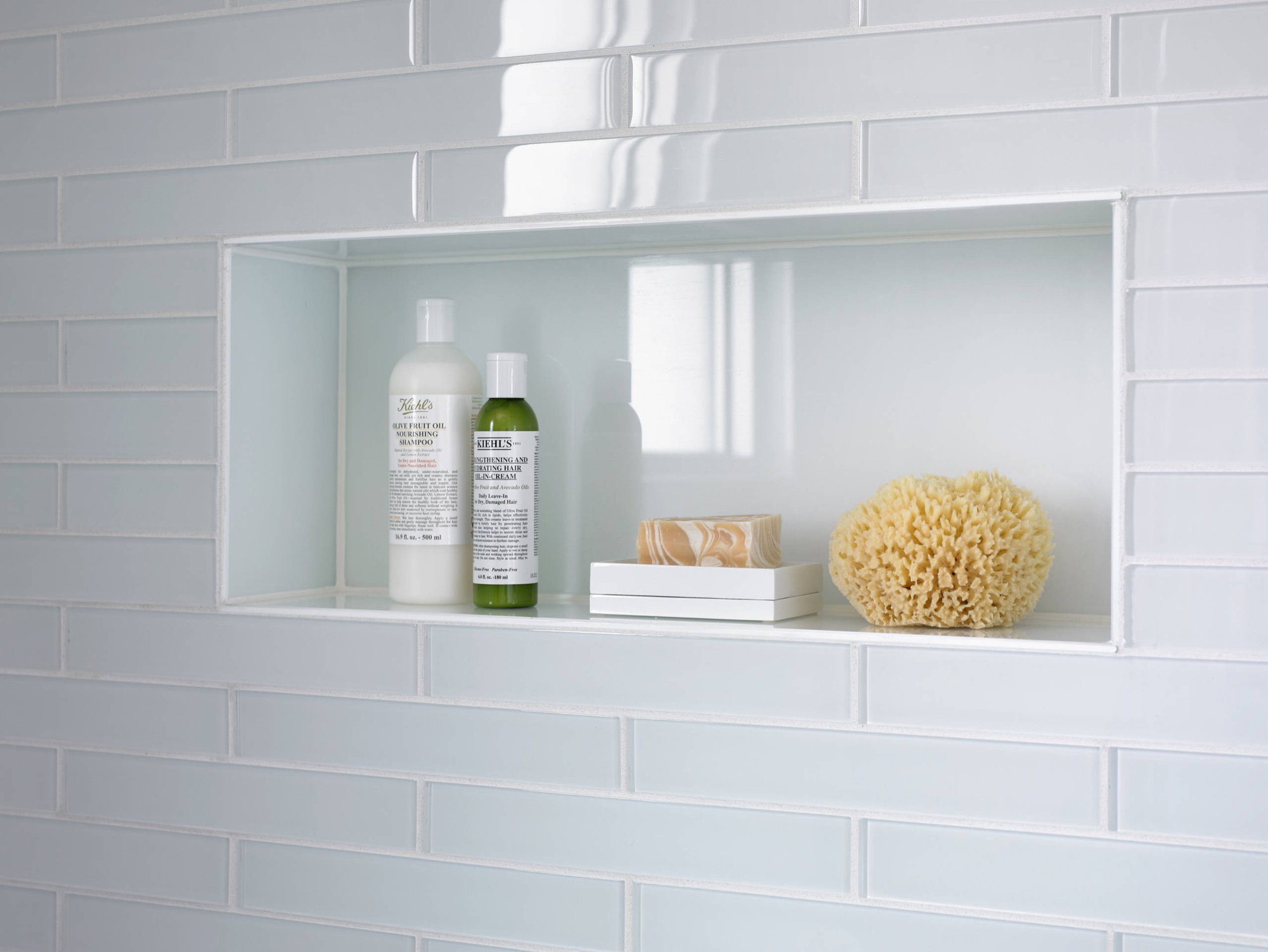 Double-wide recessed shower niche with glass subway tile surround