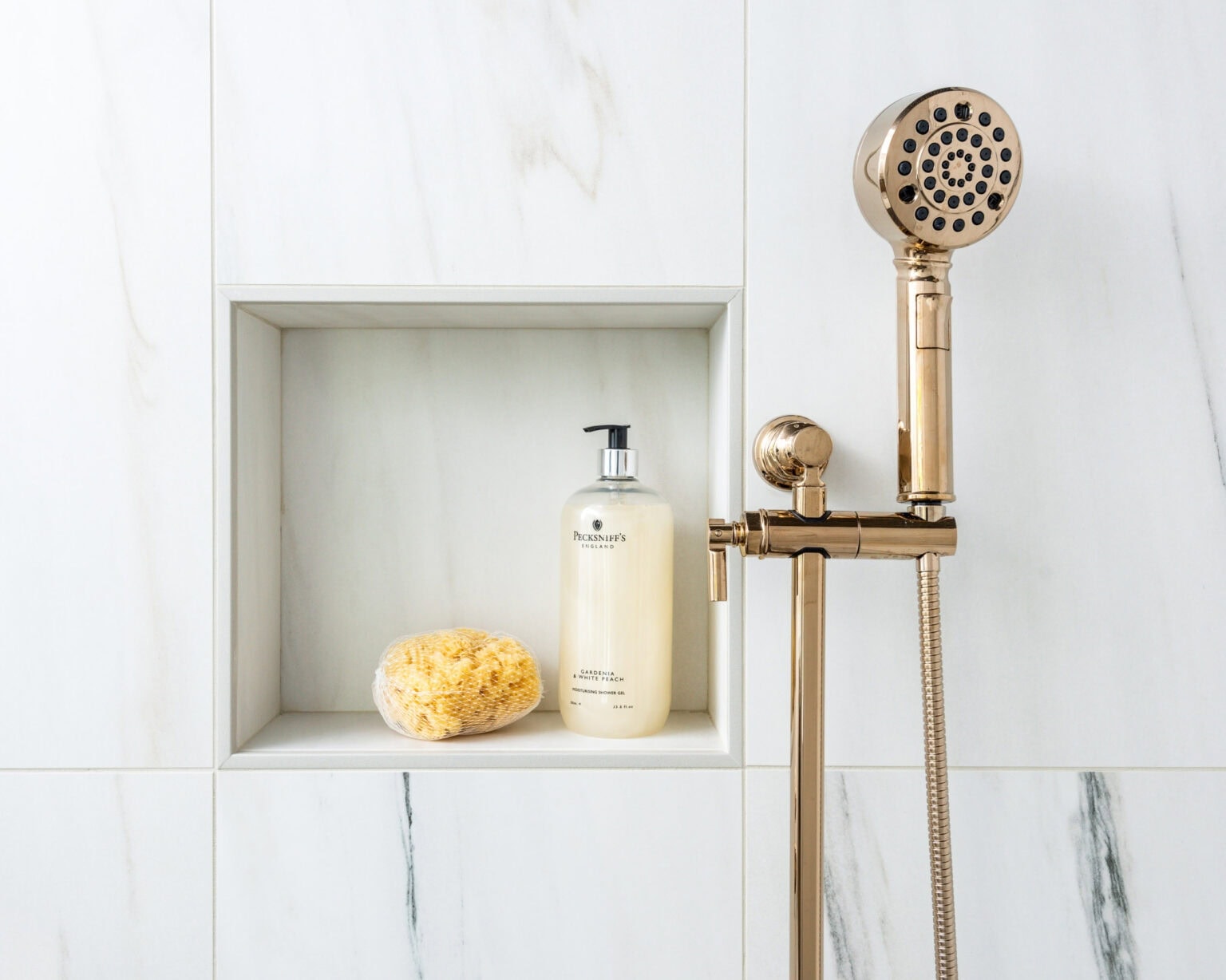 Single recessed shower niche built into tiled wall for shampoo and soap storage